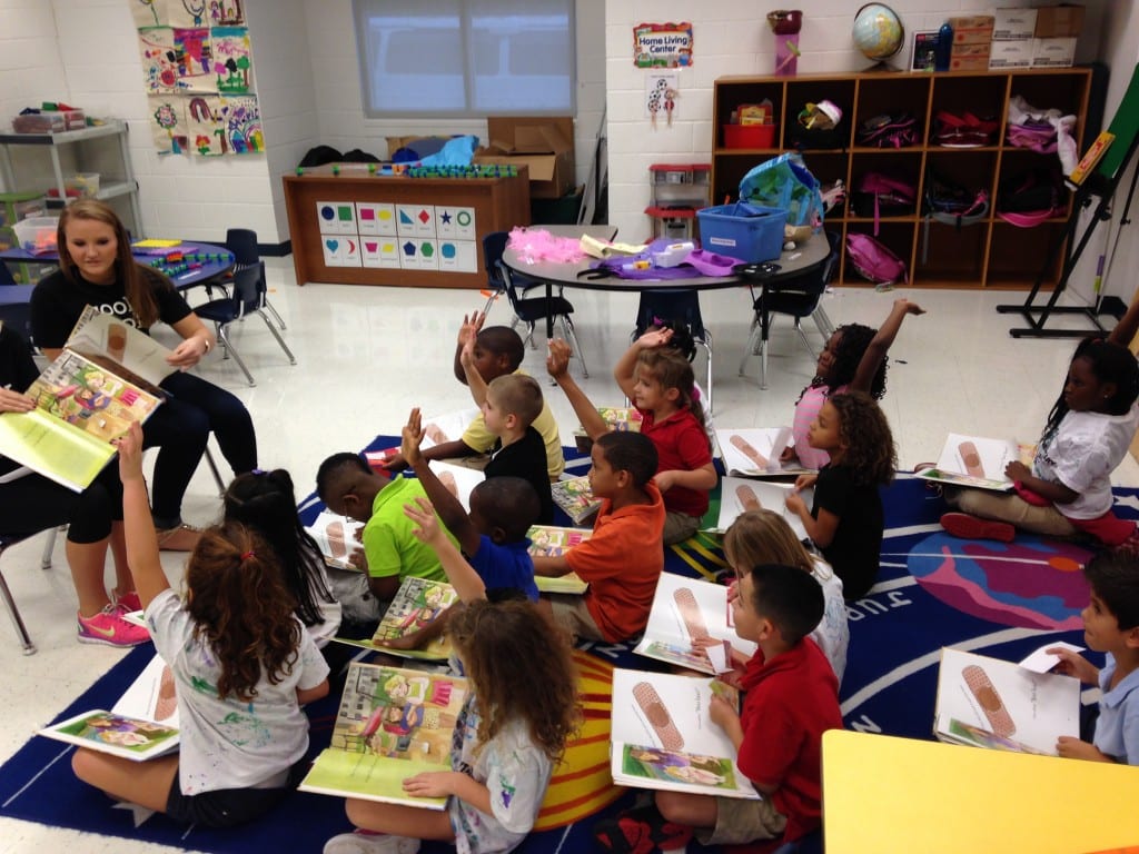 GCH_OperationOutreach_BGCCC_11-25-2013_KidsOnCarpet_Girls-Pair1_Reading_16.03.37